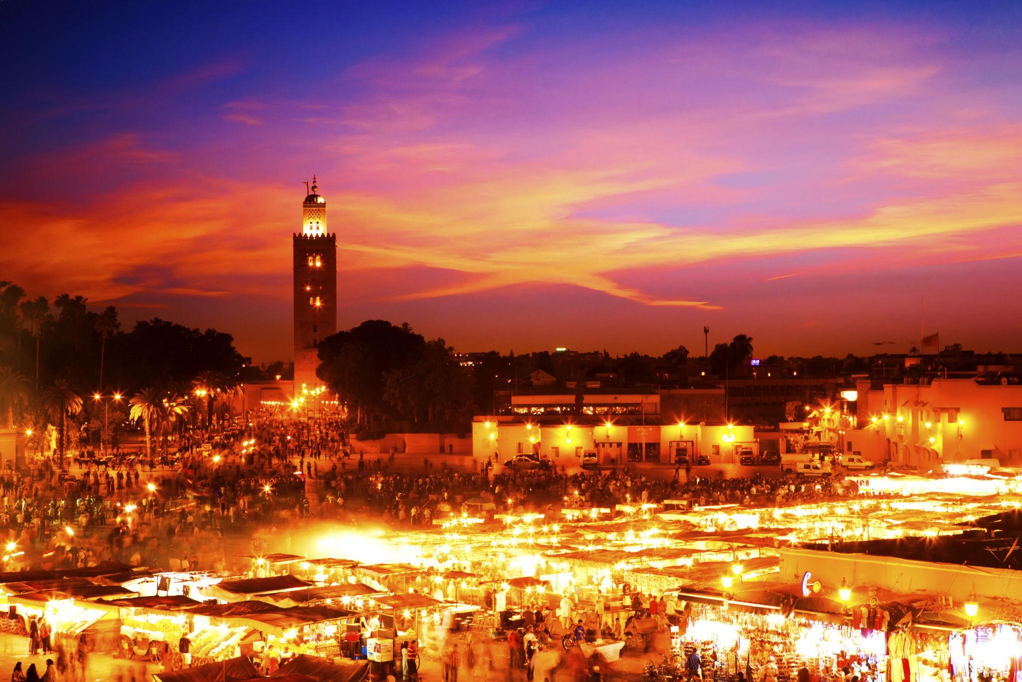 Marrakech rooftops famous dining medina lanterns sunset tagine palm trees evening Morocco