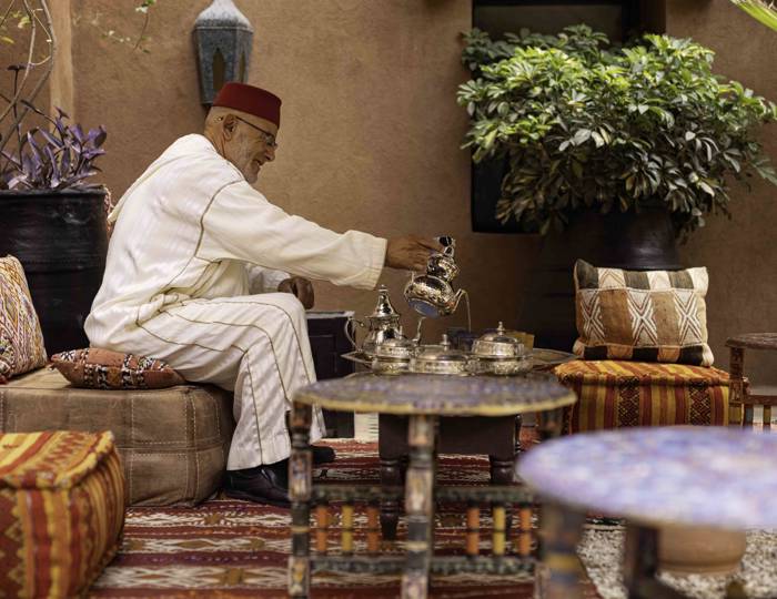 Marrakech mint tea theatre rooftop café medina view silver teapot pour ritual Morocco