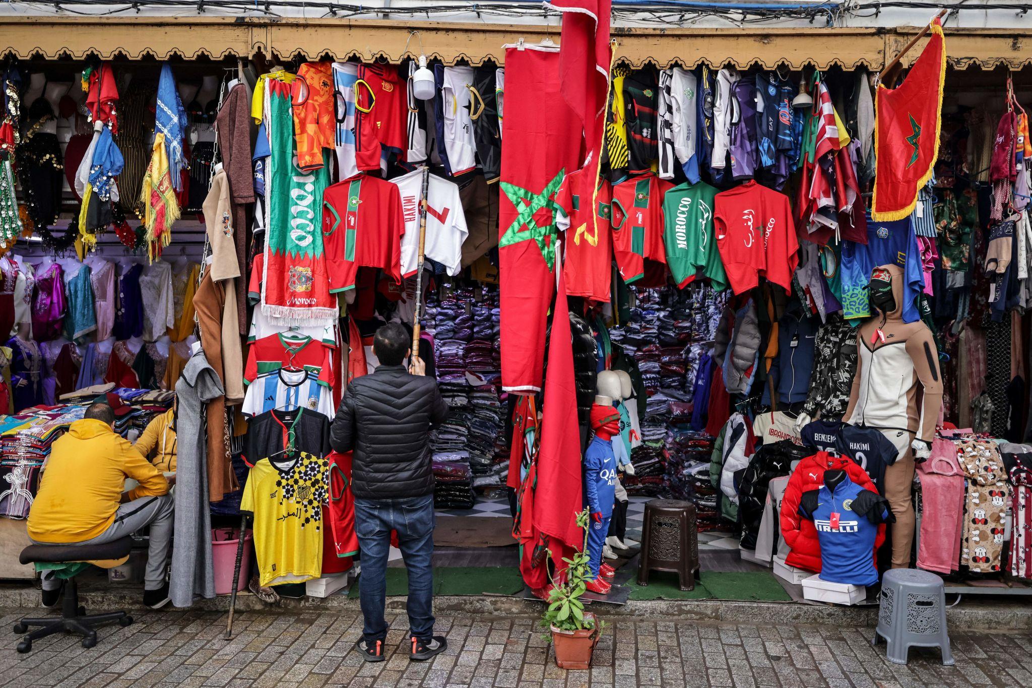 Small businesses ride wave Morocco Canada clash informal economy vendors flags shirts street football spending