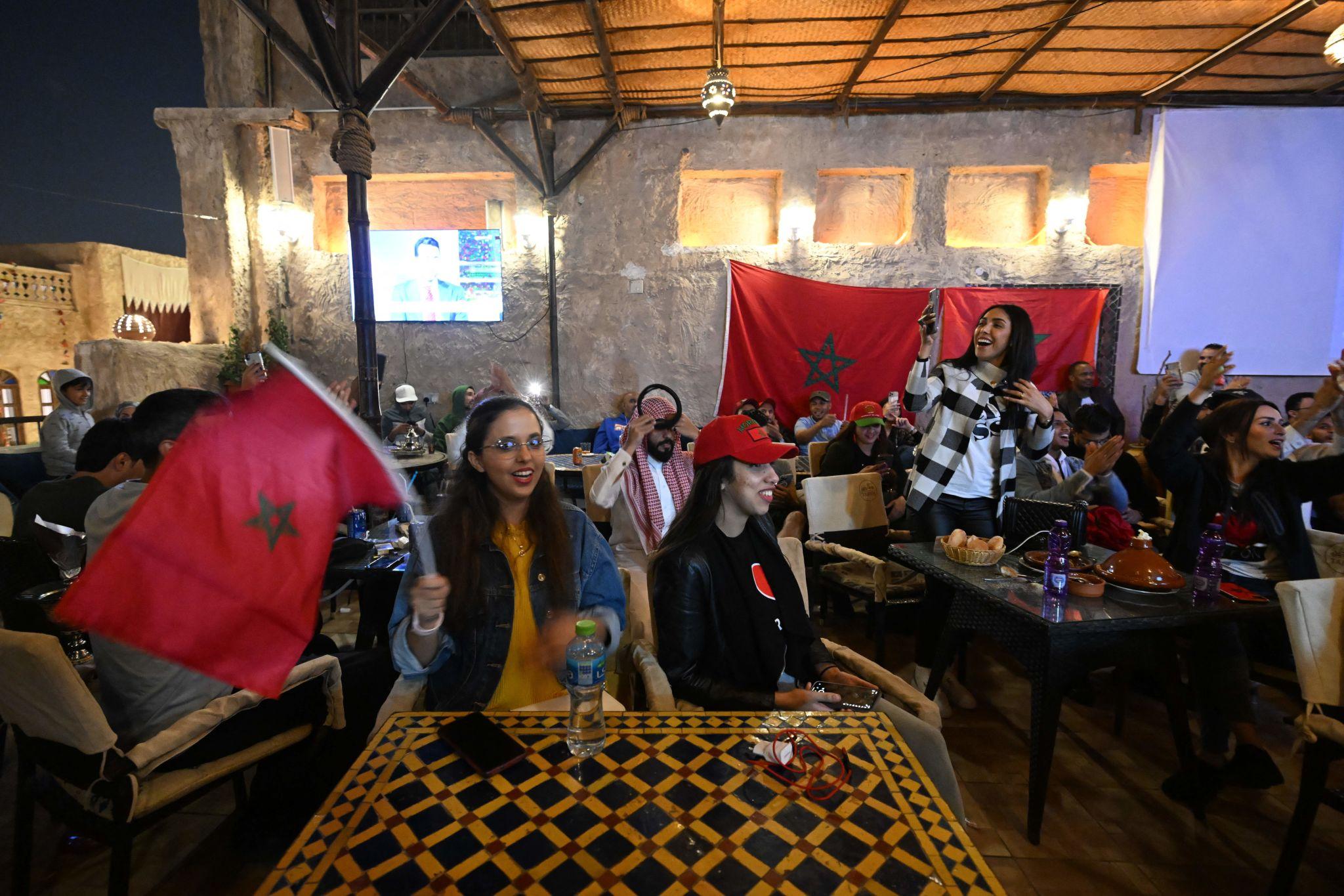 Cafes fashion stages World Cup Morocco fans shirts caps flags phone cameras match night lifestyle