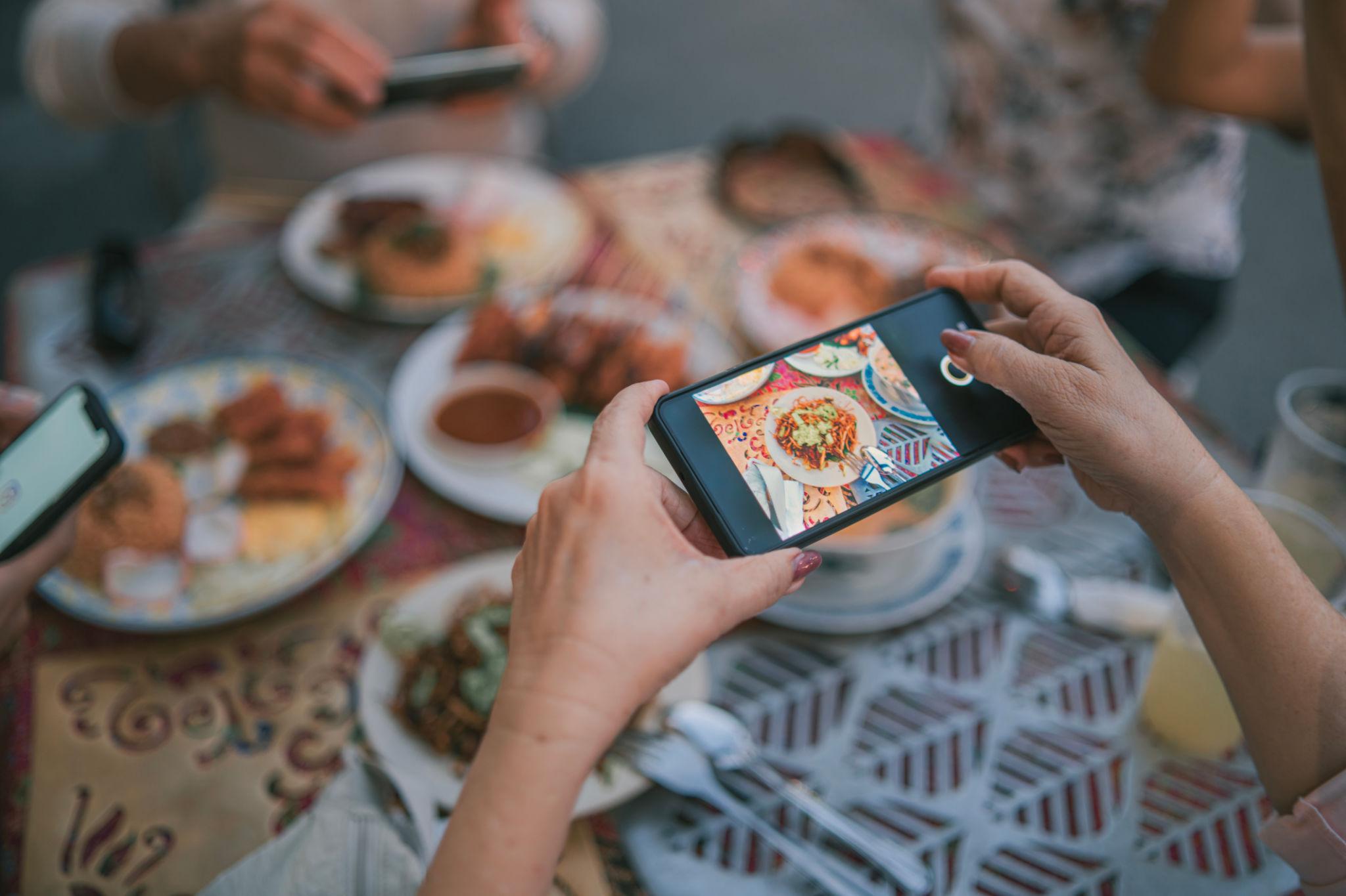 Visitors film viral street food before tasting, turning every plate into social media content